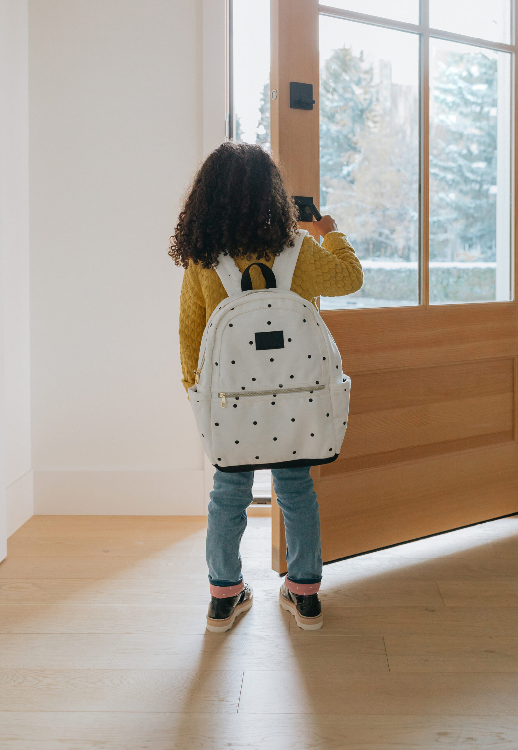 child with a backpack going back to school after doing back to school shopping with points and miles